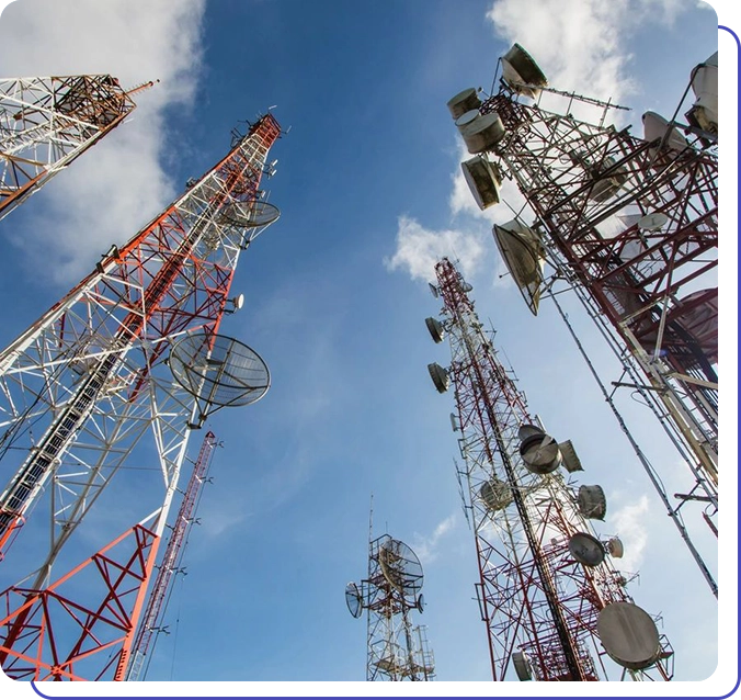 A group of telephones towers with antennas on top.